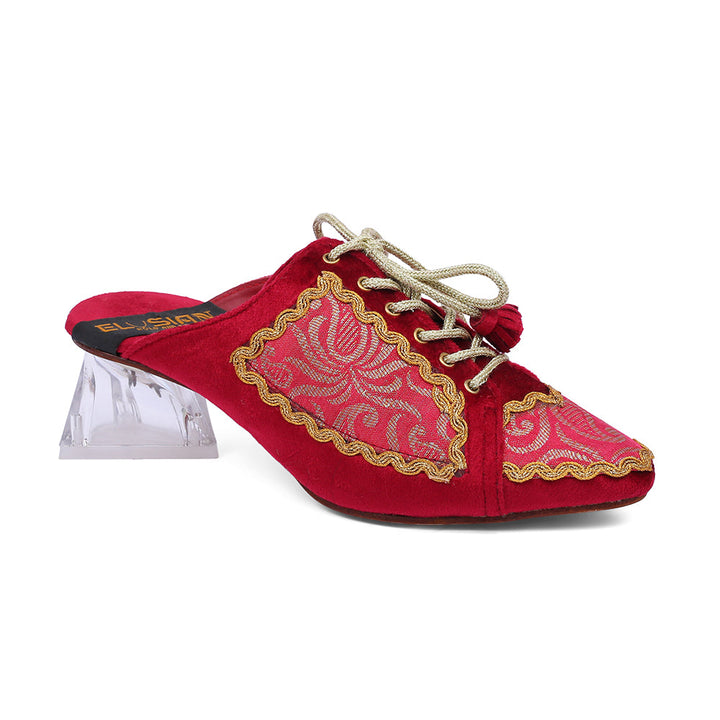 A red slipper with gold and white floral embroidery and lace-up detailing on the top