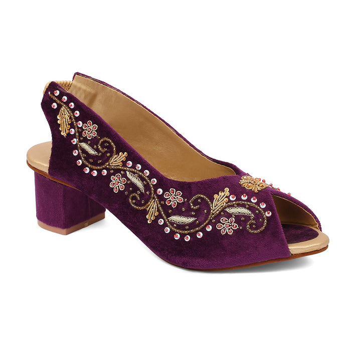 An open-toe platform wedge heel shoe crafted from ivory velvet with gold embroidery and a removable ankle strap.