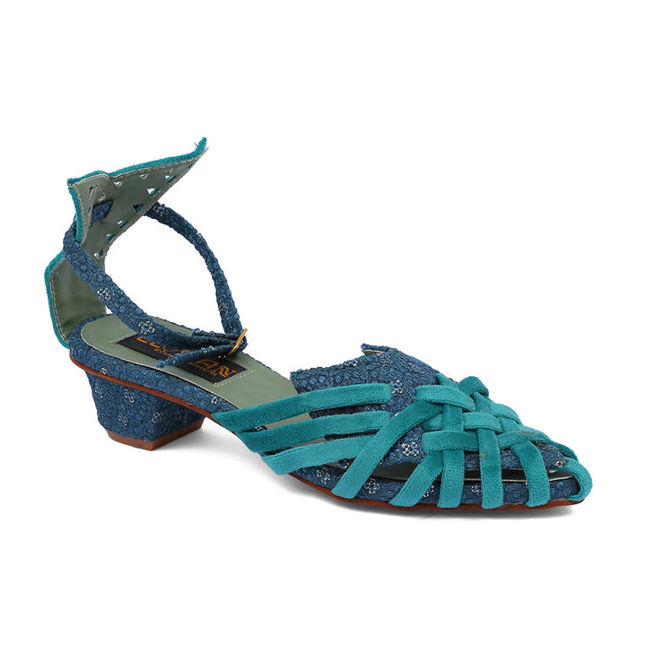 A blue sandal with intricate artistry, featuring a strappy design and a low heel.
