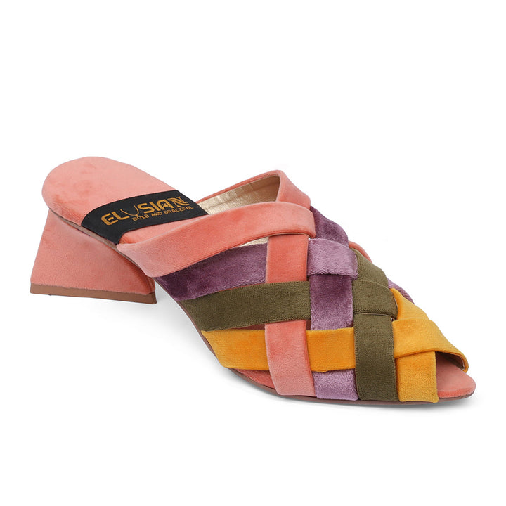 A pair of multi-colored velvet sandals with a distinctive hand-sewn design, featuring a pink base with intricate patterns and a tan sole.
