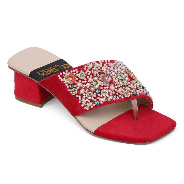 A red heeled sandal with detailed floral embroidery and a decorative strap, against a white background.