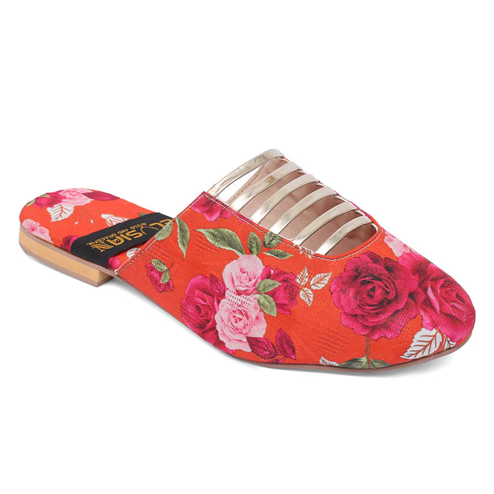 A pair of orange mules with a floral printed design, featuring gold accents on the straps.