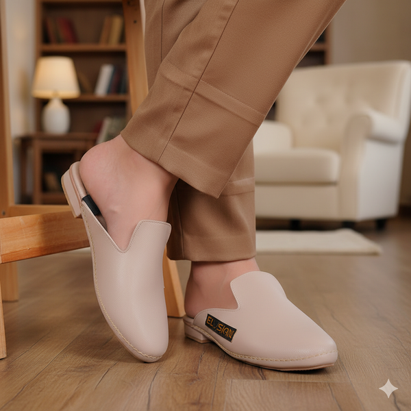 Person wearing beige slippers in a home setting